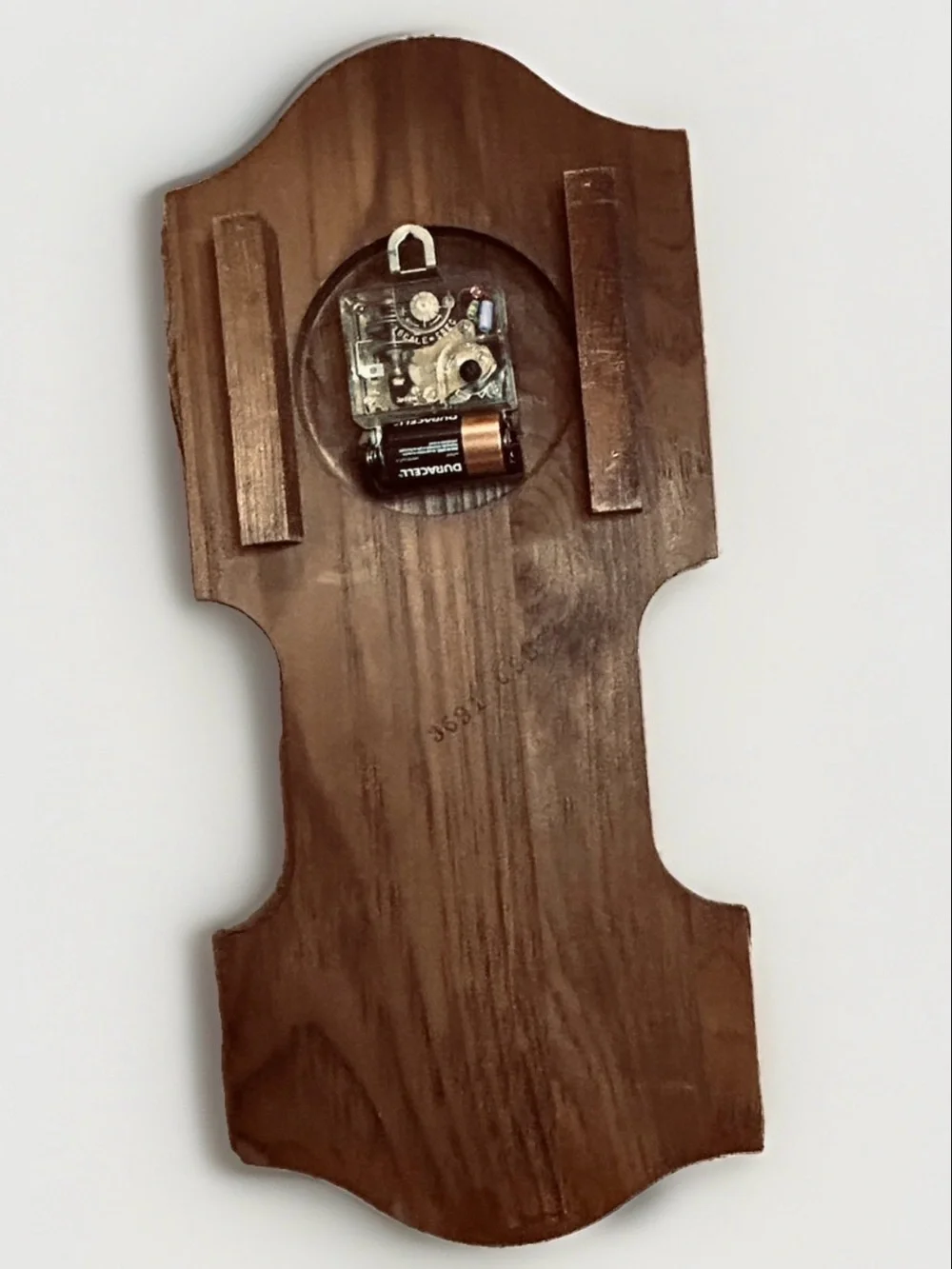 Bulova wall clock features a unique wooden casing shaped like a stylized ship